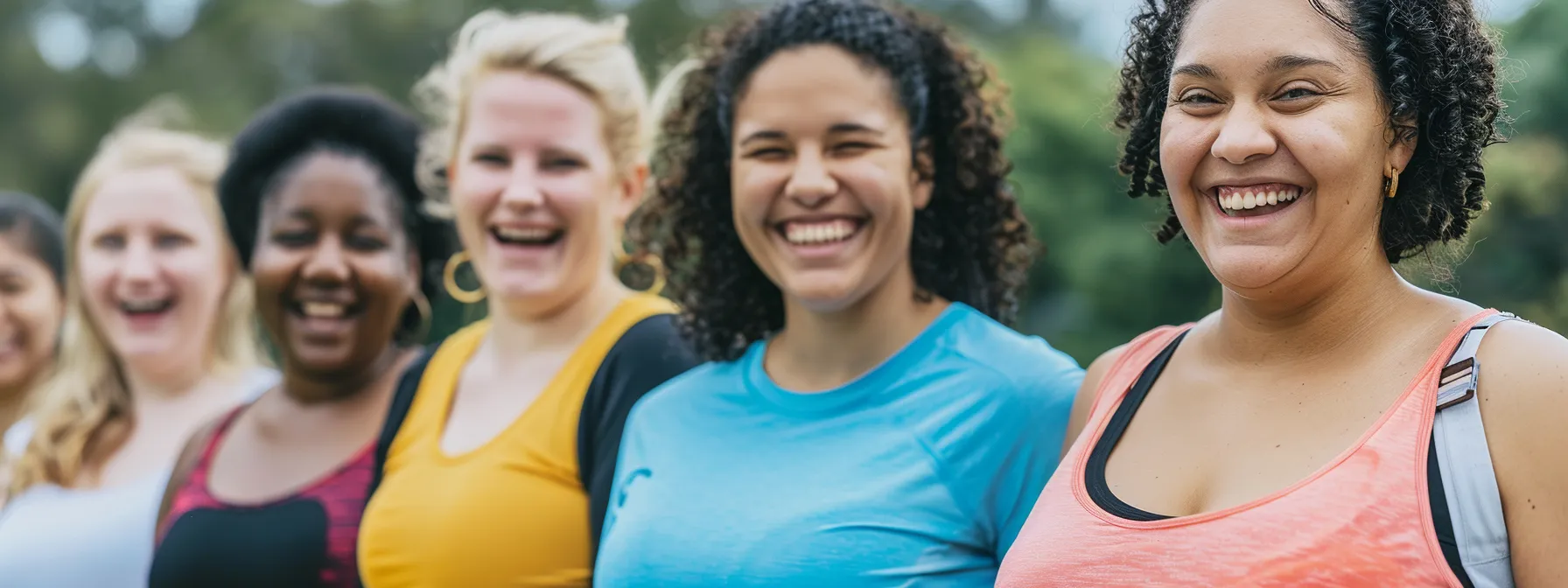 group of smiling individuals showing off their weight loss progress after championing their phentermine journey.